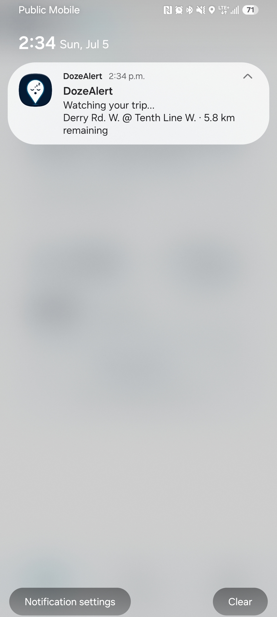 Lock screen notification showing trip monitoring with destination and distance remaining.